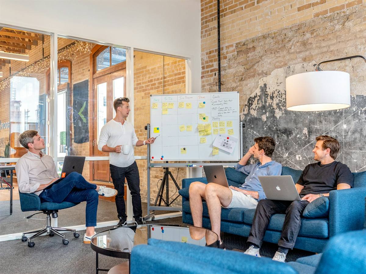A team workshop around laptops and a whiteboard