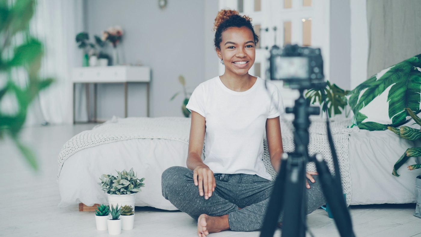 A creator filming a short video with a camera on a tripod
