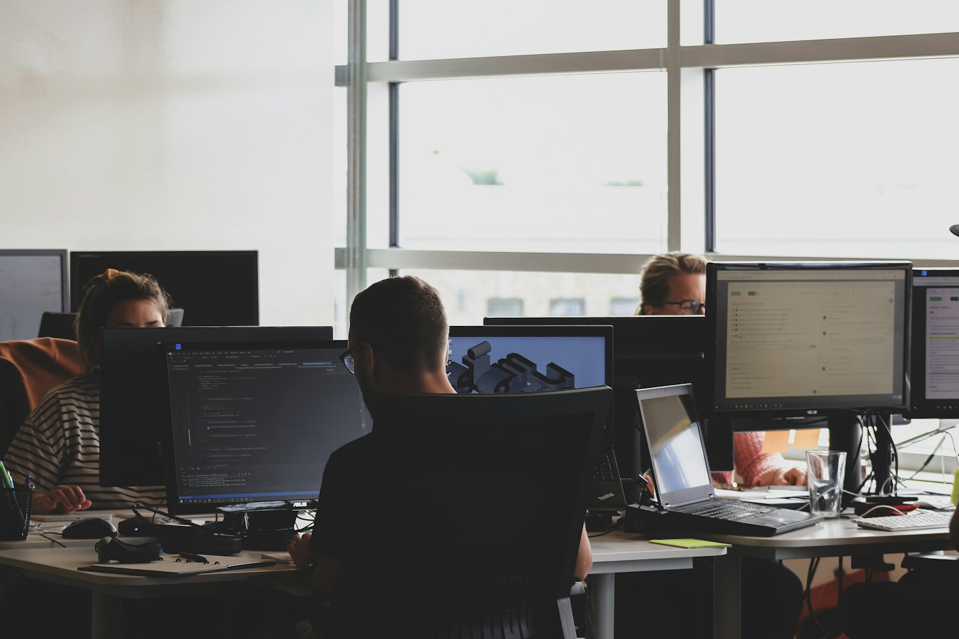 Developers at their desks in front of monitors